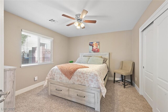 carpeted bedroom featuring visible vents, baseboards, a closet, and ceiling fan