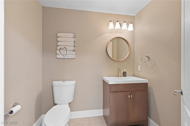 bathroom with tile patterned flooring, toilet, vanity, and baseboards