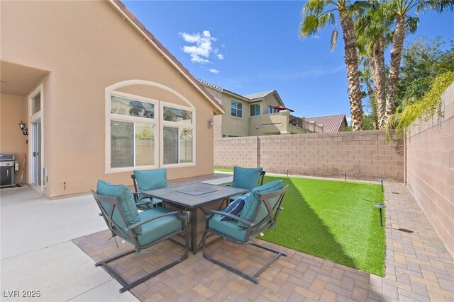 view of patio featuring fence and a grill