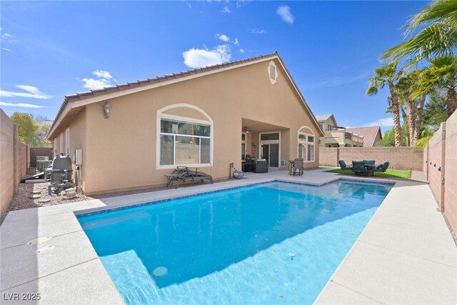 view of pool with a ceiling fan, a patio area, a fenced in pool, and a fenced backyard