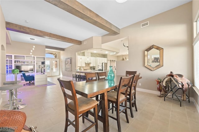 dining room with light tile patterned floors, visible vents, baseboards, french doors, and beamed ceiling