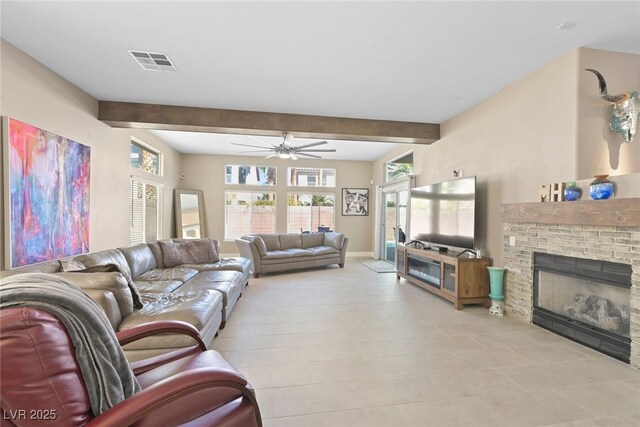 living area with baseboards, visible vents, beam ceiling, ceiling fan, and a brick fireplace