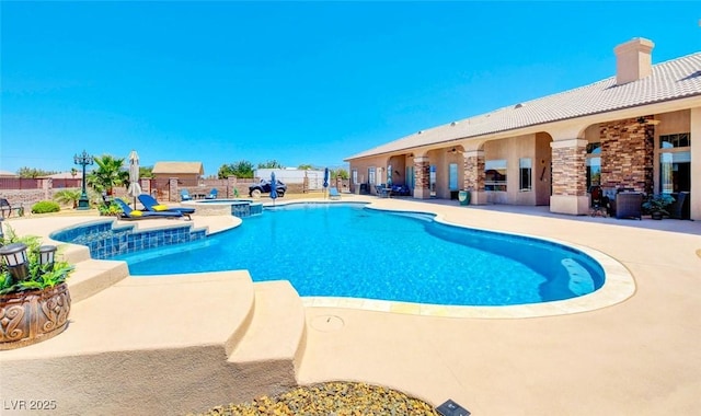 view of pool featuring a patio and a pool with connected hot tub