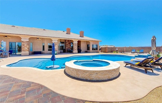 view of pool with ceiling fan, a patio area, fence, and a pool with connected hot tub