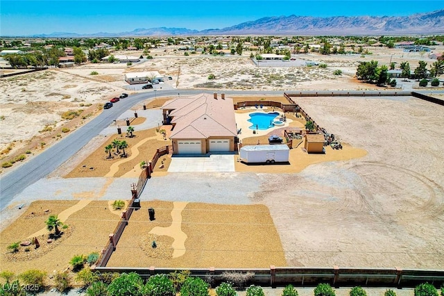 birds eye view of property with a mountain view