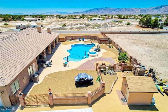 view of pool featuring a fenced backyard, a mountain view, and a patio