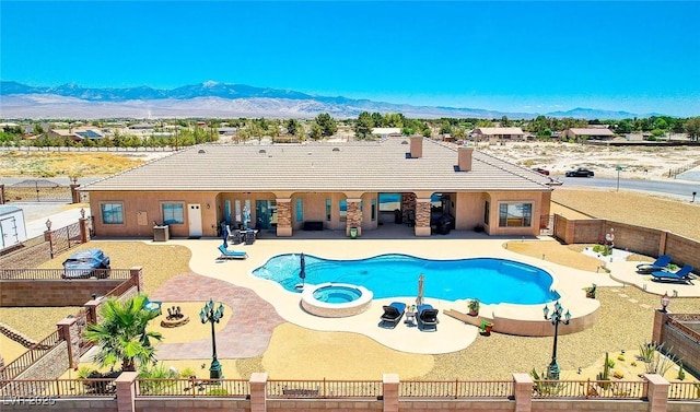 view of swimming pool featuring a patio area, a fenced backyard, a mountain view, and a fenced in pool