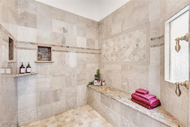 bathroom featuring a tile shower