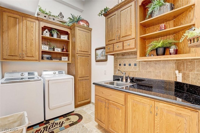 laundry area featuring cabinet space, a sink, and independent washer and dryer