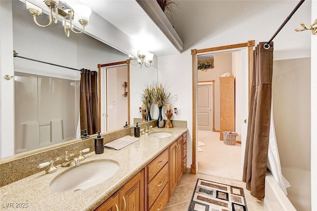 full bathroom featuring double vanity, a sink, and tile patterned floors