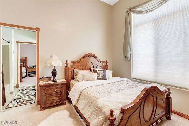 bedroom featuring light carpet, baseboards, and multiple windows