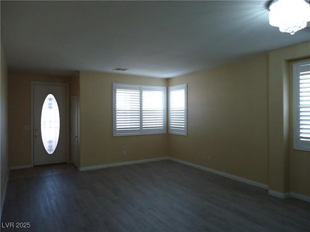 entrance foyer featuring plenty of natural light, wood finished floors, visible vents, and baseboards