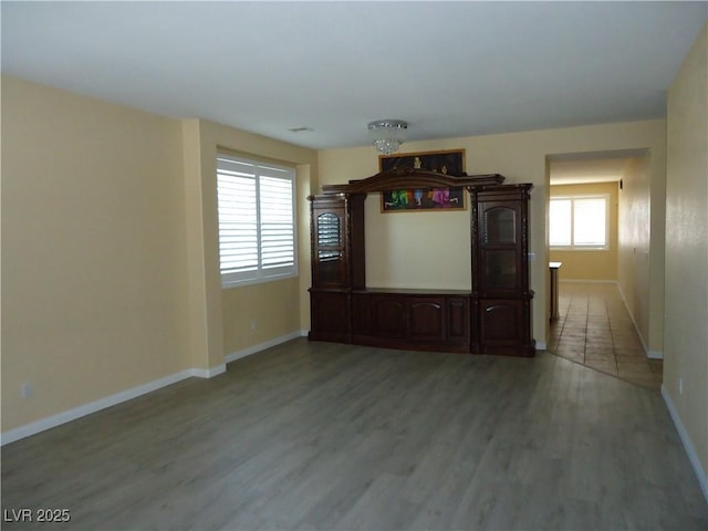 empty room with light wood-style floors and baseboards