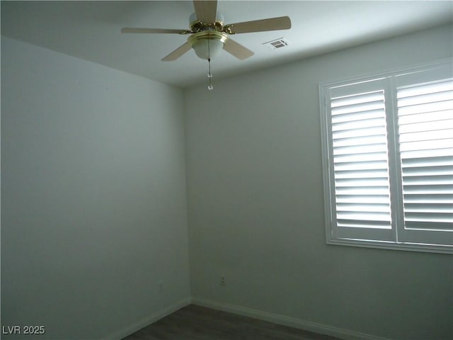 spare room with visible vents, ceiling fan, and baseboards