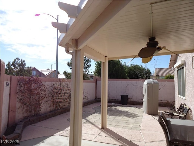 view of patio with a fenced backyard and a ceiling fan