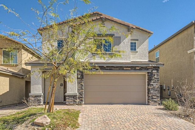 traditional home featuring an attached garage, stone siding, decorative driveway, and stucco siding