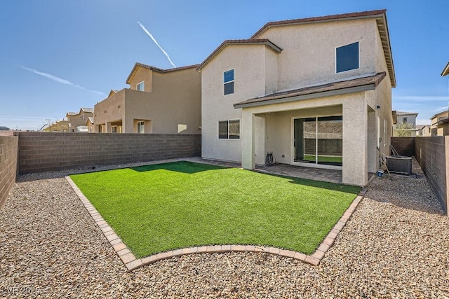 back of house with a lawn, a patio, a fenced backyard, cooling unit, and stucco siding