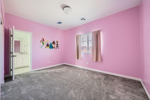 carpeted empty room featuring visible vents and baseboards