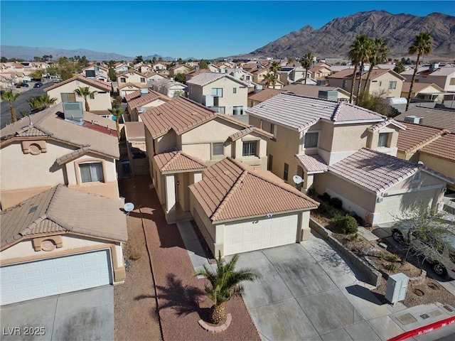 birds eye view of property with a mountain view and a residential view