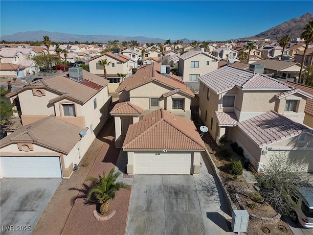 drone / aerial view with a residential view and a mountain view