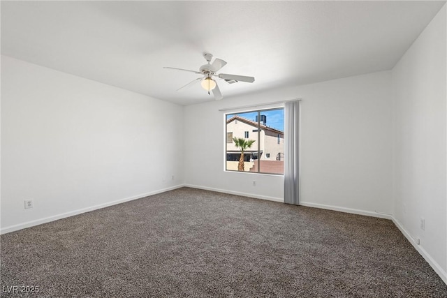 unfurnished room featuring dark colored carpet, a ceiling fan, and baseboards