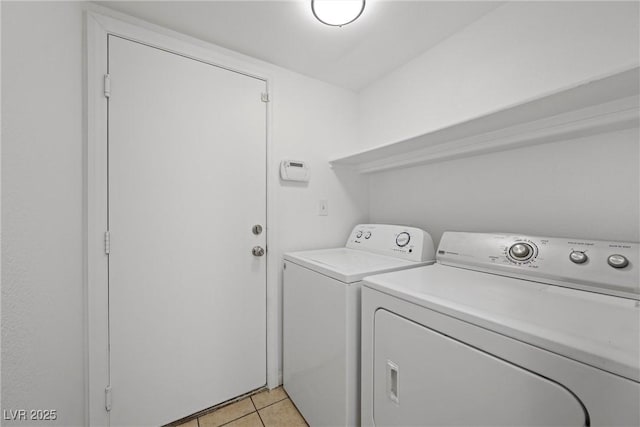 clothes washing area with light tile patterned floors, laundry area, and independent washer and dryer