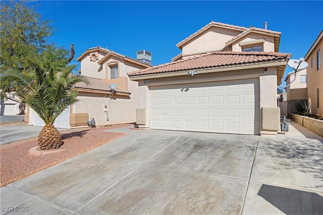 mediterranean / spanish home featuring stucco siding, concrete driveway, an attached garage, central AC unit, and a tiled roof