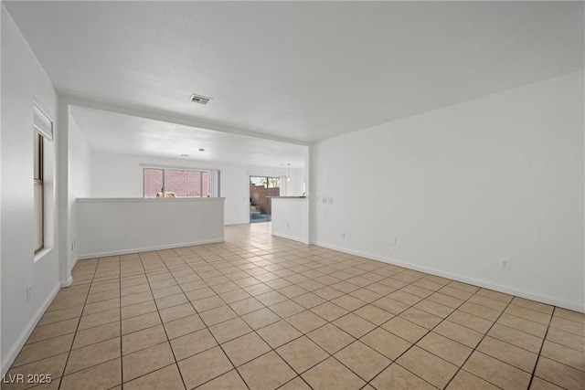 unfurnished room with visible vents and baseboards