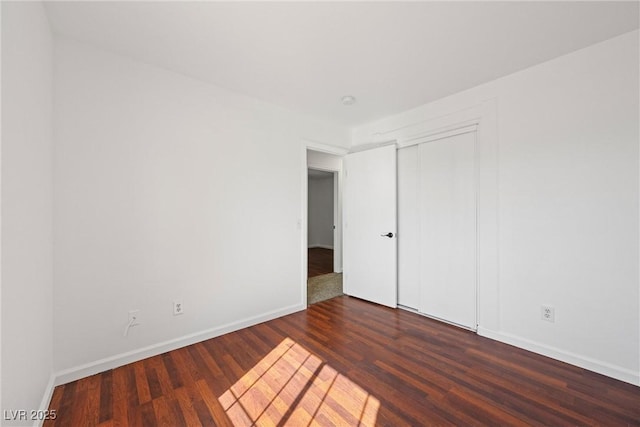 empty room with wood finished floors and baseboards