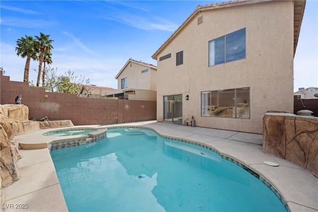 view of pool with a patio, a fenced backyard, and a pool with connected hot tub