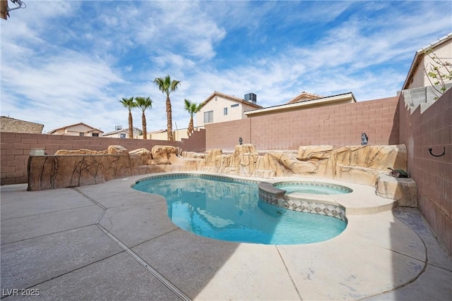 view of swimming pool with a patio, a fenced backyard, and a pool with connected hot tub