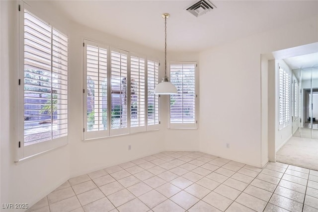 unfurnished dining area with light tile patterned floors and visible vents