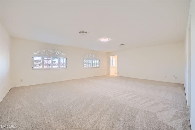 empty room with light colored carpet and visible vents