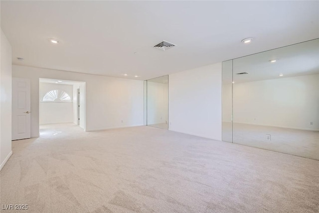 carpeted empty room with recessed lighting and visible vents