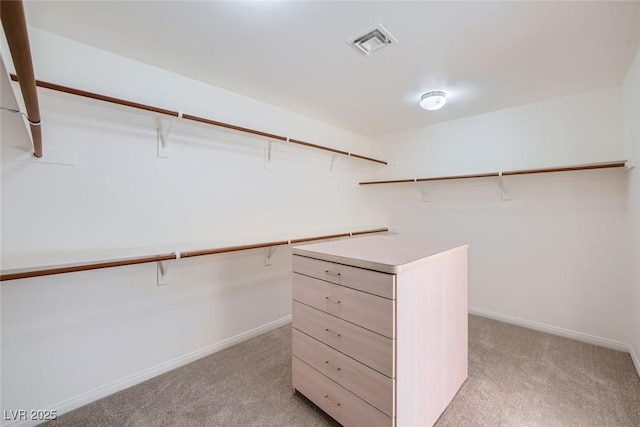 walk in closet with light carpet and visible vents