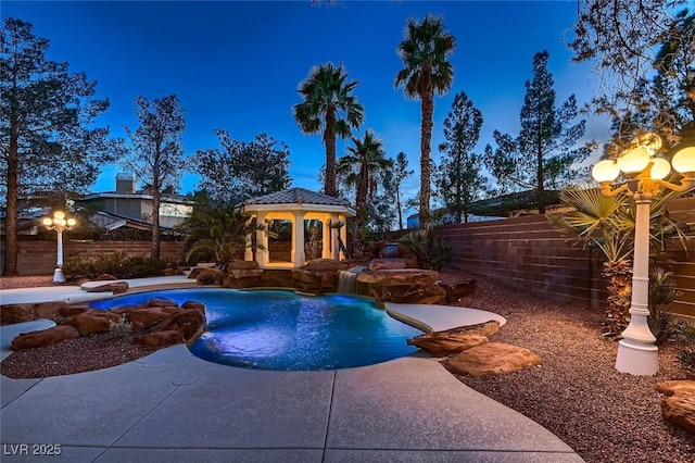 view of pool featuring a fenced backyard, a patio, a fenced in pool, and a gazebo