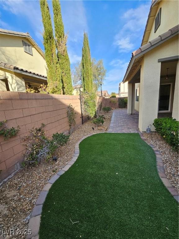 view of yard with a fenced backyard and a patio