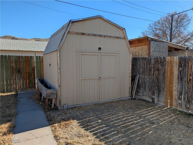 view of shed with fence