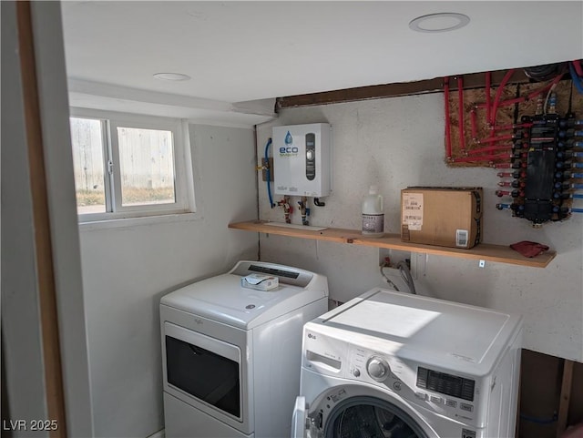 clothes washing area with water heater, laundry area, and washer and clothes dryer