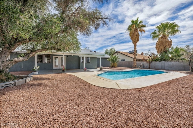 view of pool with a fenced in pool, french doors, a fenced backyard, and a patio