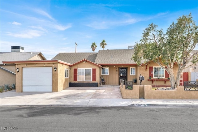 ranch-style home featuring a fenced front yard, stucco siding, a shingled roof, a garage, and driveway