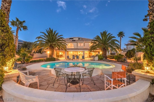 outdoor pool with a patio area