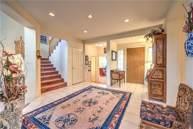 entrance foyer with stairs, light tile patterned flooring, and recessed lighting