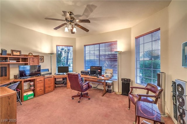 office space with light colored carpet and ceiling fan