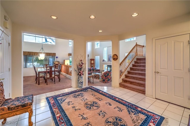 entrance foyer featuring tile patterned flooring, recessed lighting, and stairs