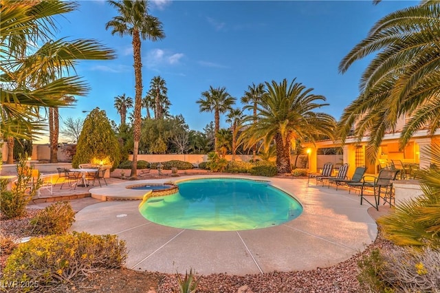 view of pool with a patio and a pool with connected hot tub