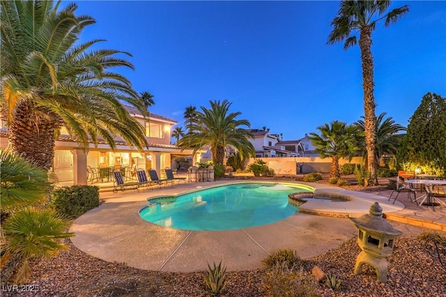 view of swimming pool with a pool with connected hot tub and a patio area