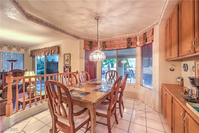 dining area featuring a notable chandelier and light tile patterned floors