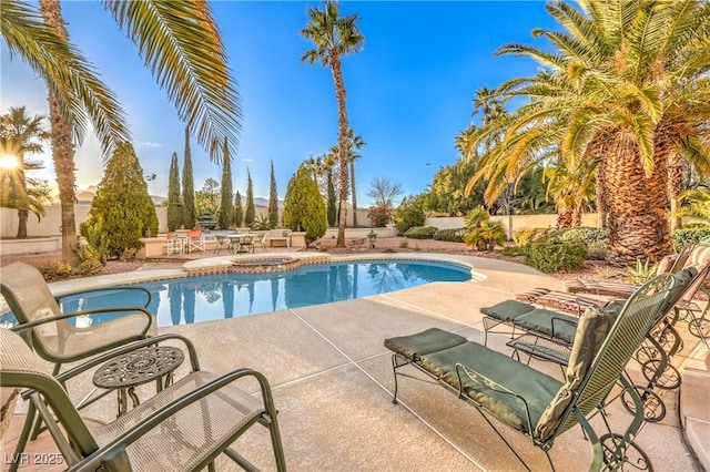 view of pool featuring a patio area, a fenced in pool, an in ground hot tub, and fence