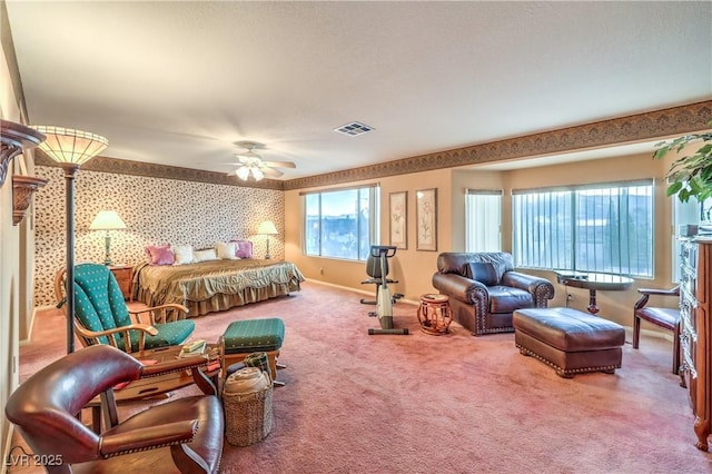 bedroom featuring visible vents, carpet flooring, wallpapered walls, baseboards, and ceiling fan